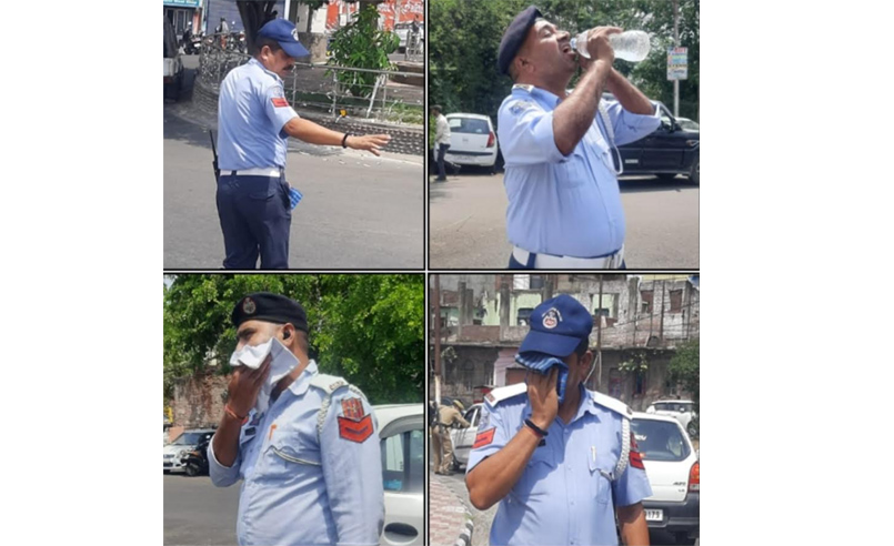 As mercury soars, Traffic Cops sweat out under searing sun and regulates traffic in Jammu City